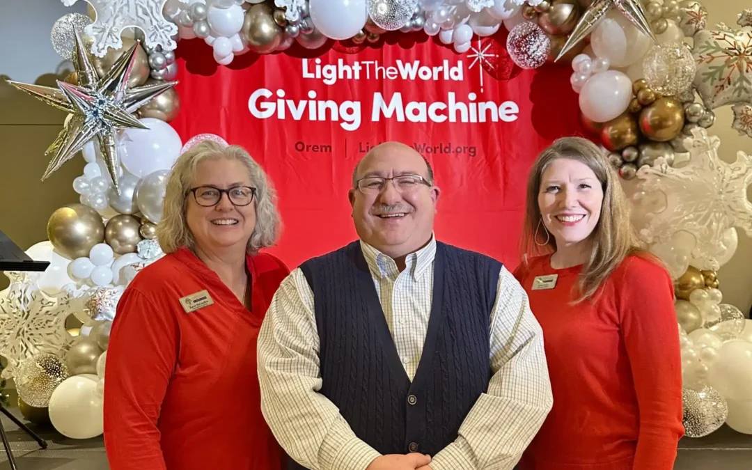 Red Giving Machine sign with 3 people in image